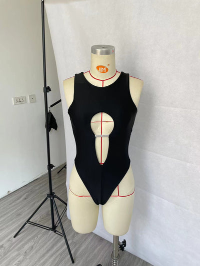 Women's black one-piece swimsuit with a high neck, chest cut-out, and rhinestone embellishment, modeled in a pool. - Image 11