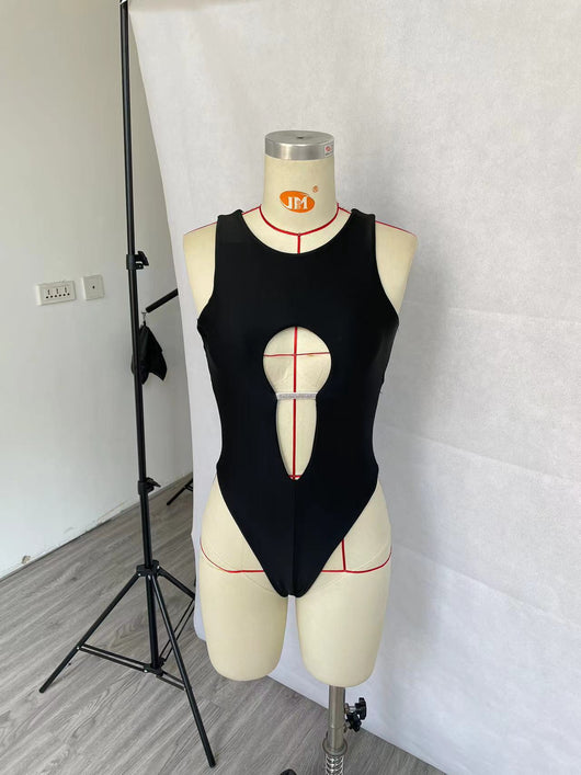 Women's black one-piece swimsuit with a high neck, chest cut-out, and rhinestone embellishment, modeled in a pool. - Image 11