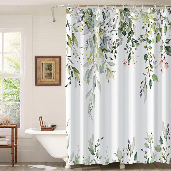 White shower curtain with a vibrant green botanical leaf print, hanging in a bright, modern bathroom.