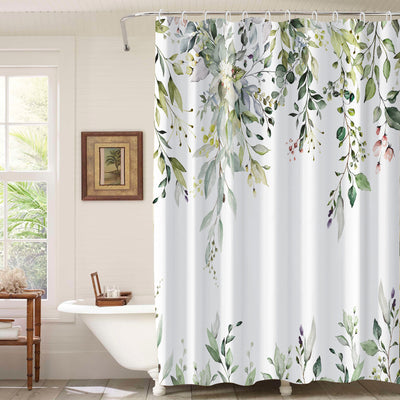 White shower curtain with a vibrant green botanical leaf print, hanging in a bright, modern bathroom.
