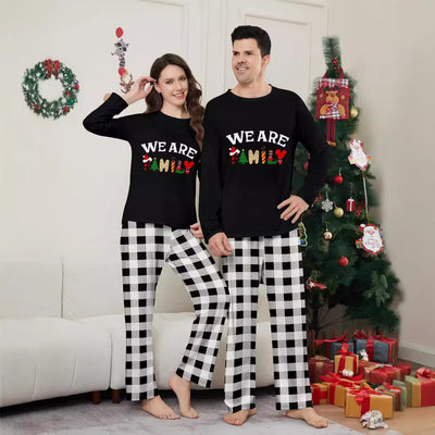 Family of four wearing matching black long-sleeve pajamas with "WE ARE FAMILY" text and black and white plaid bottoms. - Image 2