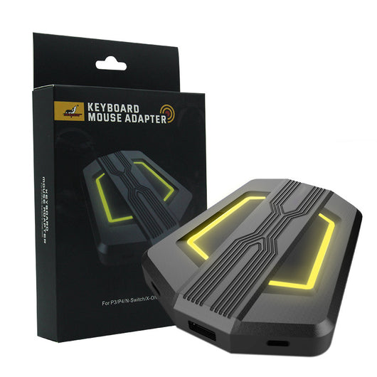 Black keyboard and mouse adapter for gaming consoles with yellow LED accents, next to its product box. - Image 9