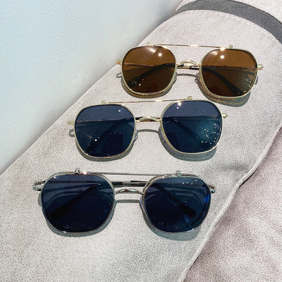 Gold frame flip-up sunglasses with brown lenses, featuring a double-layer design and black temple tips.