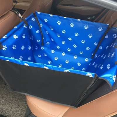 Brown pet car mat with colorful dog pattern installed in a car's rear seat, protecting upholstery. - Image 8