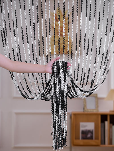 Brown and beige striped string curtain with twisted tassel texture, held by a hand, for living room partition. - Image 20