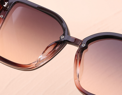 Women's black cat-eye sunglasses with large frames, gradient gray lenses, and gold-tone accents. - Image 20