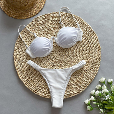 Rust underwire bikini set with ruched top and high-cut bottom, displayed on a woven mat. - Image 4