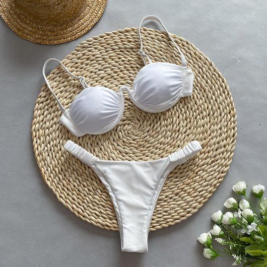 Rust underwire bikini set with ruched top and high-cut bottom, displayed on a woven mat. - Image 4