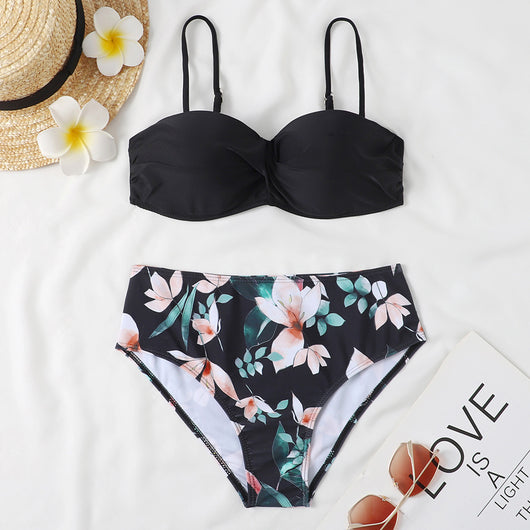 Teal twisted bandeau bikini top with tropical leaf print high-waisted bottoms on a model wearing a white shirt. - Image 9