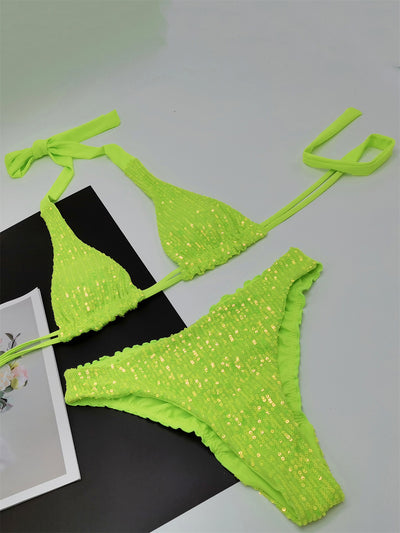 Pink and yellow sequined halter bikini top and high-cut bottoms on a model against a clear blue sky. - Image 32