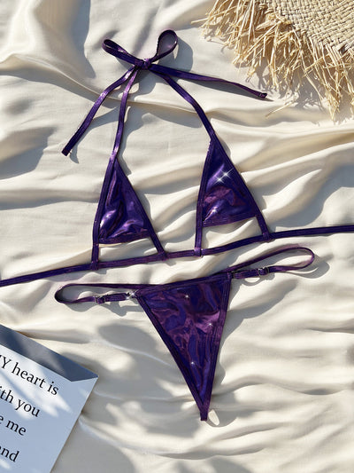 Shiny purple pearlescent micro bikini with a halter top and g-string bottom, modeled by a woman outdoors. - Image 4