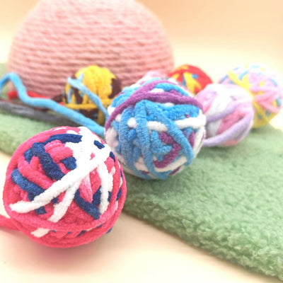 Colorful plush wool ball cat toys with long yarn tails, featuring various patterns and a bell inside for play. - Image 3