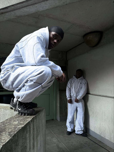 Light gray hooded tracksuit with dark gray contrast stitching, featuring a full-zip hoodie and matching loose sweatpants. - Image 15