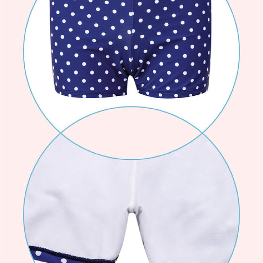 Woman in a cute and sweet three-piece swimsuit with a sheer white polka dot long-sleeve top and navy blue polka dot swim skirt. - Image 10
