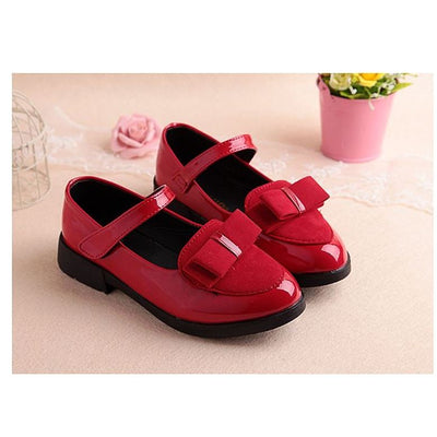 Black patent Mary Jane shoes for girls with a strap, round toe, and a black suede bow with a silver accent. - Image 4