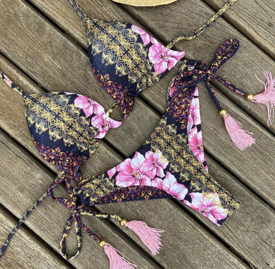 Women's tropical floral print bikini with a halter top, ruffled edges, and tie-side bottoms with pink tassels. - Image 16