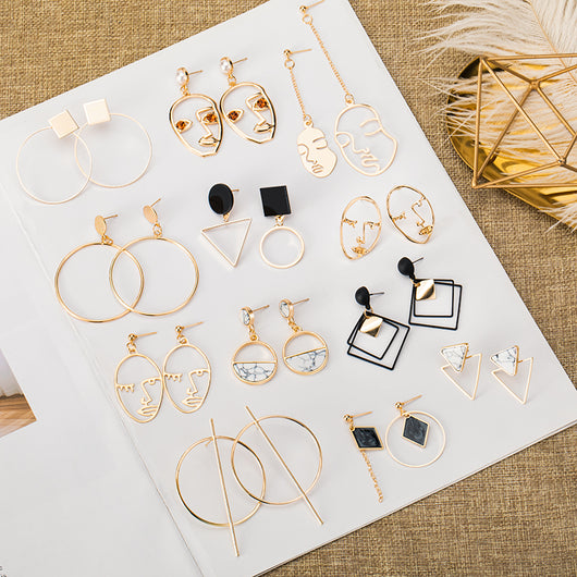Pair of silver geometric round hoop earrings with a small circular stud and thin, large hoops. - Image 6