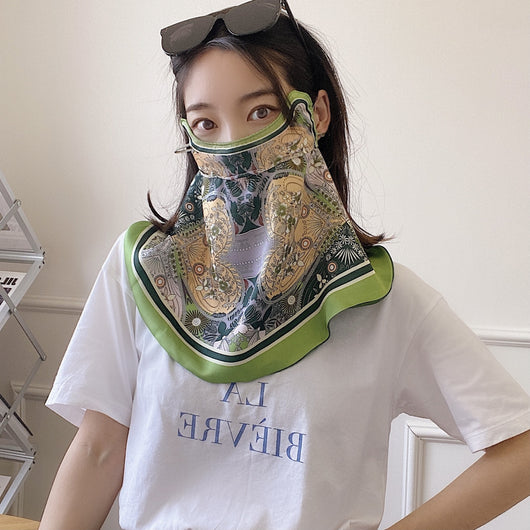 Female cream and black floral polka dot sun protection mask with ear loops, designed for eye corner protection. - Image 3