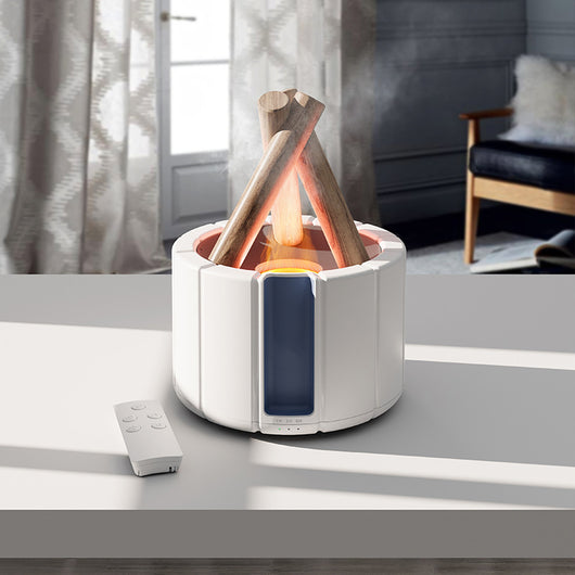 Dark gray simulated flame aromatherapy machine with a remote control, emitting a warm, flame-like light and mist.