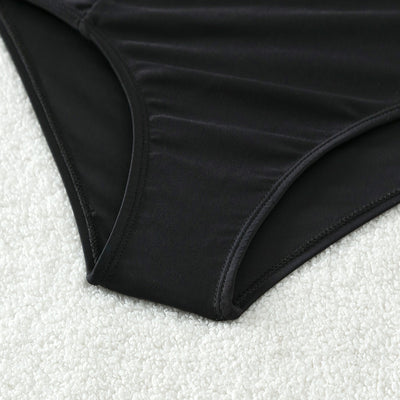 Girls' two-piece bikini swimsuit with a colorful striped crop top and solid black high-waisted ruched bottoms. - Image 5