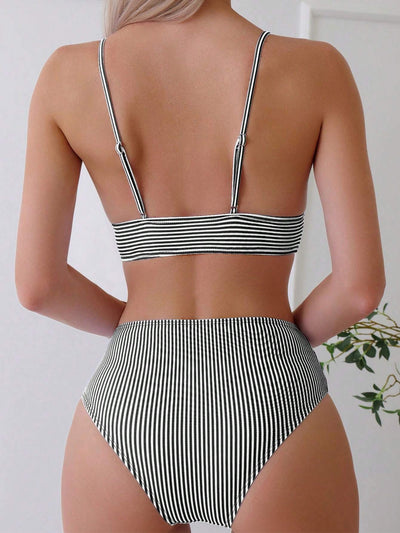 Green and white striped two-piece bikini with a triangle top and high-waisted bottoms on a woman. - Image 25