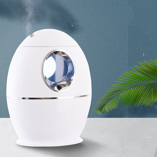 White egg-shaped household humidifier with a blue-lit circular opening and silver trim. - Image 3