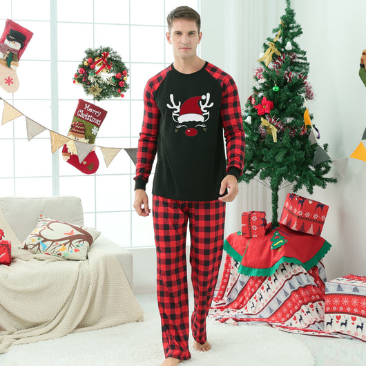 Matching family Christmas pajamas with black tops, red and black plaid sleeves, and glittery leopard print Christmas trees. - Image 5