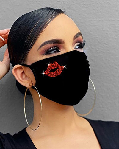 Black cotton face mask with a rhinestone flower design and "Be Kind" in pink rhinestones, worn by a person. - Image 3