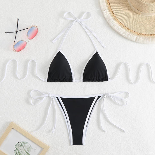 Royal blue two-piece bikini with light blue trim and tie straps, laid flat on a white textured surface. - Image 19