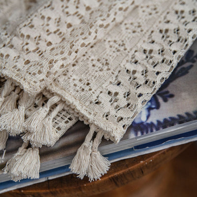 Translucent off-white American Country hollow crochet curtain with intricate patterns and tassel trim, draped by a window. - Image 5