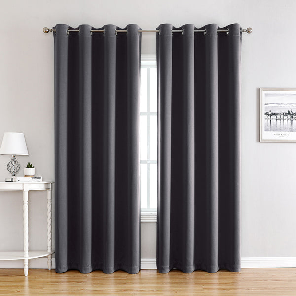 Pair of beige blackout curtains with grommet tops, made of polyester, hanging on a silver rod. - Image 5