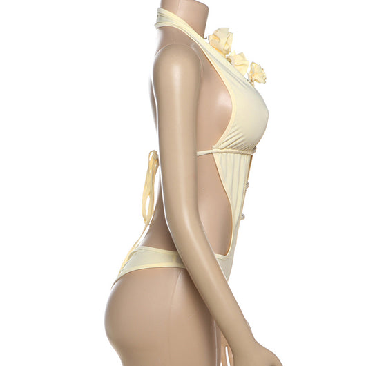 White halter monokini with deep V-neck, side cut-outs, and pearl bead embellishments on a woman at the beach. - Image 39