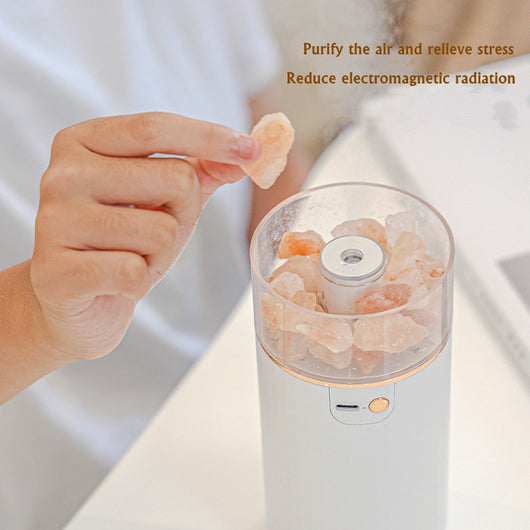 Pink cylindrical humidifier and essential oil diffuser with glowing orange crystal salt stones and a clear base. - Image 3