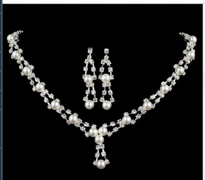 Silver-tone bridal jewelry set with a pearl and rhinestone necklace and matching dangle earrings. - Image 4