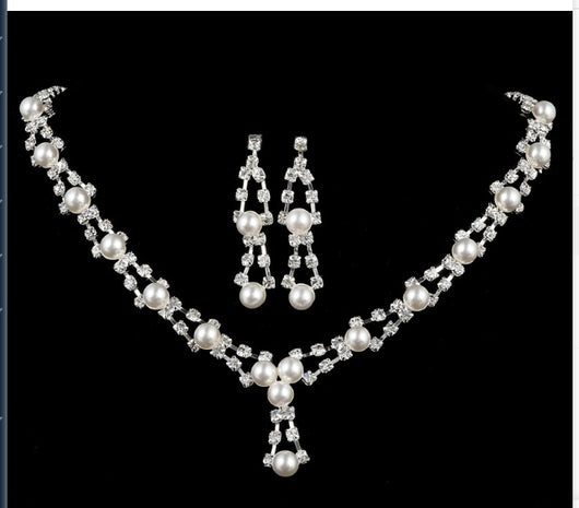 Silver-tone bridal jewelry set with a pearl and rhinestone necklace and matching dangle earrings. - Image 4