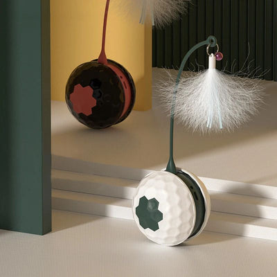 White and dark green cat teaser toy with a golf ball textured base and a flexible arm topped with white feathers.