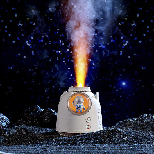White spaceman humidifier with an orange-lit window featuring a small astronaut figure and a glowing top light. - Image 9