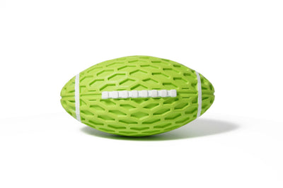 Orange rubber rugby ball dog toy with honeycomb texture and white laces, being squeezed by a hand. - Image 12
