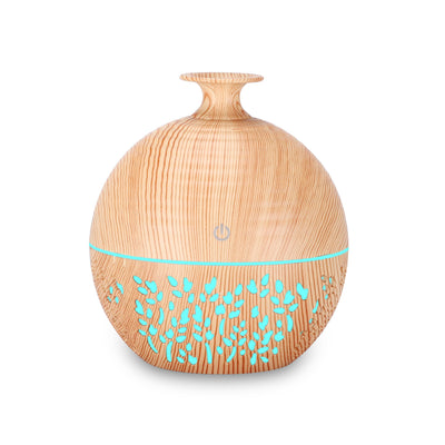 Light wood grain portable mini aroma diffuser humidifier with a vase shape and glowing blue leaf patterns. - Image 12