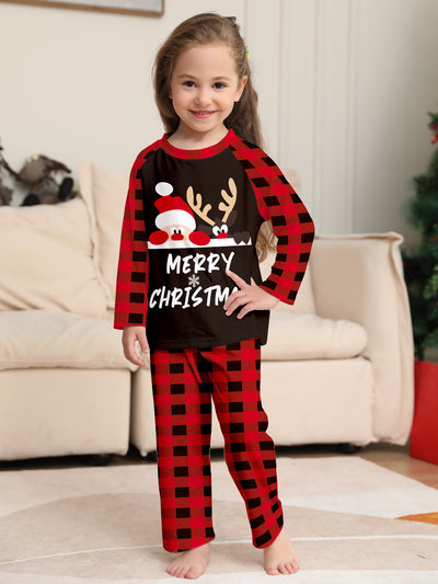 Family of four wearing matching red and black buffalo plaid Christmas pajamas with reindeer graphic. - Image 4