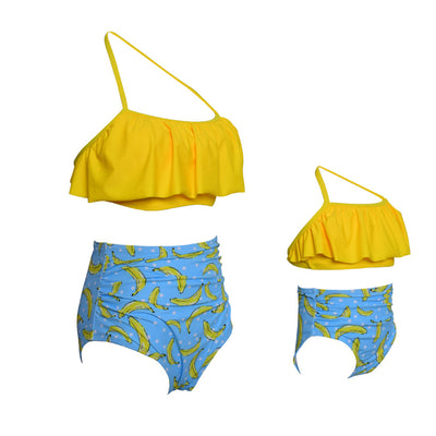 Black wrap bikini top with high-waisted pink and green tropical leaf print swim bottoms. - Image 3