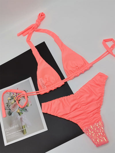 Pink and yellow sequined halter bikini top and high-cut bottoms on a model against a clear blue sky. - Image 29