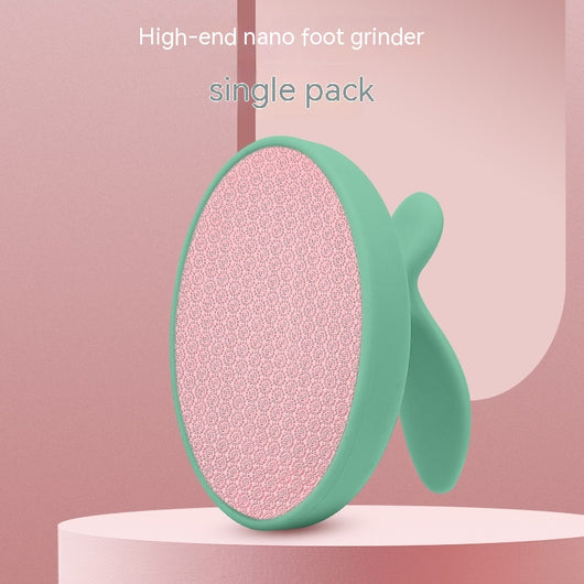 Pink oval nano foot grinder with a textured surface and ergonomic handle, designed for exfoliating and removing calluses. - Image 3
