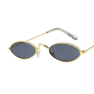 Retro oval frame sunglasses with vibrant red lenses and shiny gold-colored metal frames on a white background.