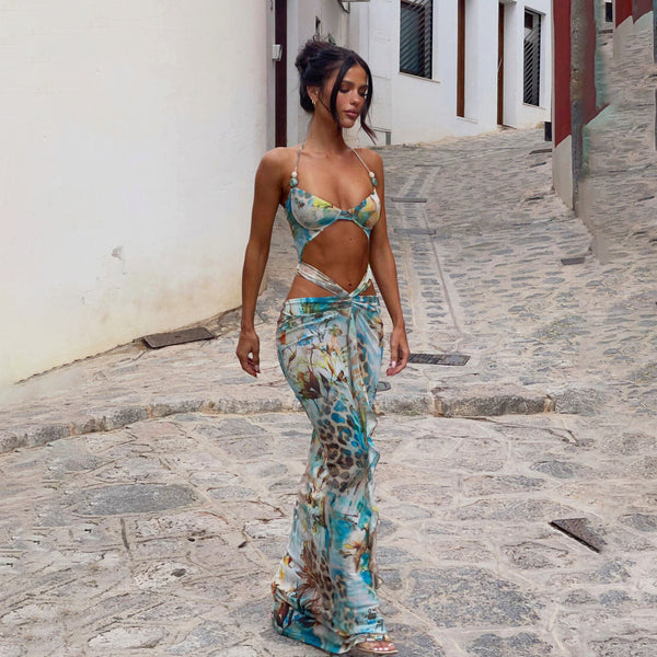 Women's two-piece swimsuit with a halter bikini top and a matching long skirt, featuring a vibrant tropical and animal print.