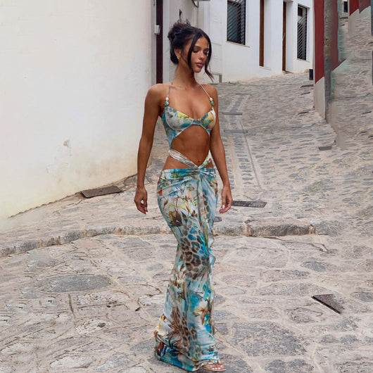 Women's two-piece swimsuit with a halter bikini top and a matching long skirt, featuring a vibrant tropical and animal print.