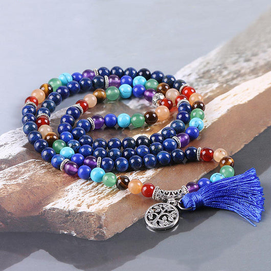 Blue mala prayer beads with chakra colored gemstones, a silver Tree of Life charm, and a blue tassel. - Image 3