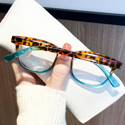 Women's retro leopard print presbyopic glasses with anti-blue light clear lenses and a blue gradient bottom frame. - Image 3