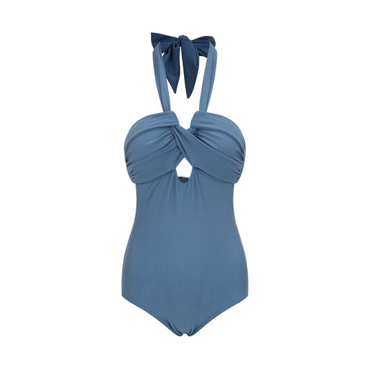 Woman wearing a taupe ribbed one-piece swimsuit with a halter neckline and twisted bust detail on a sandy beach. - Image 11