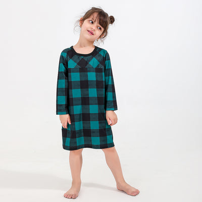 Family of four and dog wearing matching green and black plaid pajamas. Mother and father in two-piece sets, girl in dress, baby in two-piece, and dog in bandana - Image 10